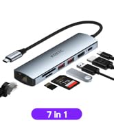 7-in-1 USB-C hub adapter with multiple ports. Slim silver device connects to various peripherals and memory cards.