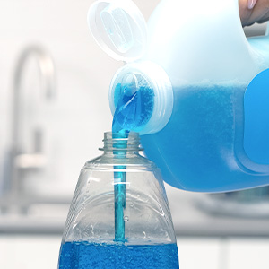 A person refilling a bottle of Dawn Ultra using a Dawn Ultra refill jug.