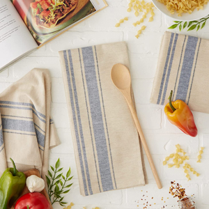 A kitchen countertop with DII French Stripe dish towels for baking and cooking