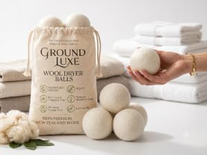 Six wool dryer balls stored beside a reusable cotton bag