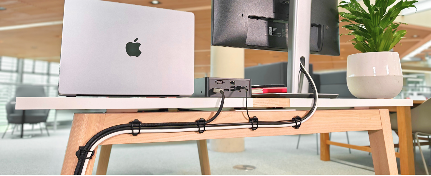 Proudct holding cables behind desk.