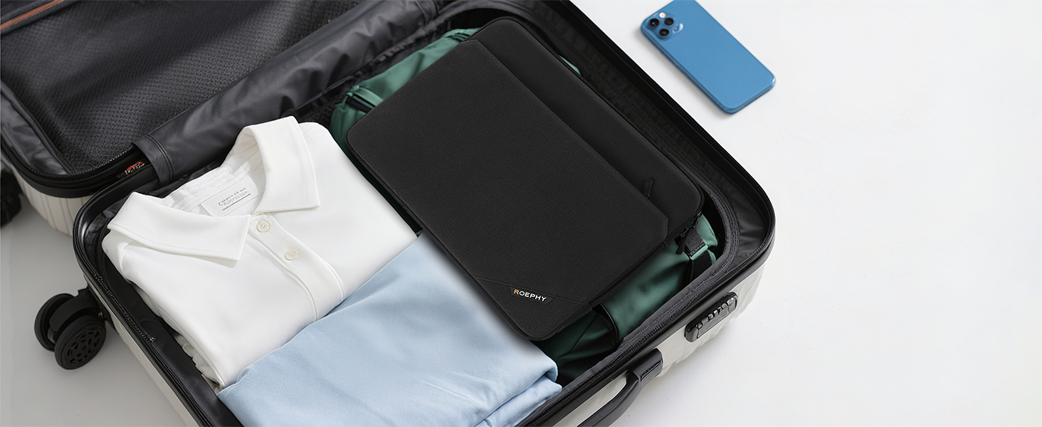 Open suitcase containing neatly folded white clothing with a blue smartphone placed on top, showing organized packing arrangement.