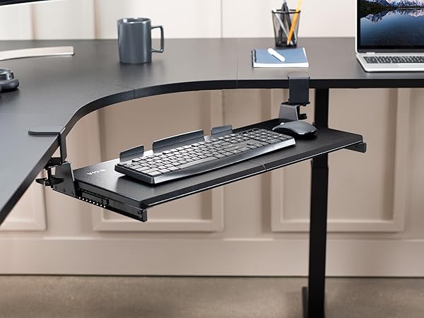 Keyboard tray secured to corner desk with swiveling desk clamps