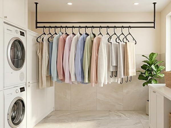 Laundry room: transferring dry clothes onto black hangers straight from dryer. No wrinkling
