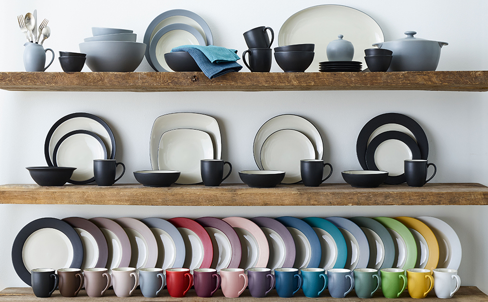 Colorwave dinnerware on shelves, showing a rainbow row of plates, place settings, and accessories.