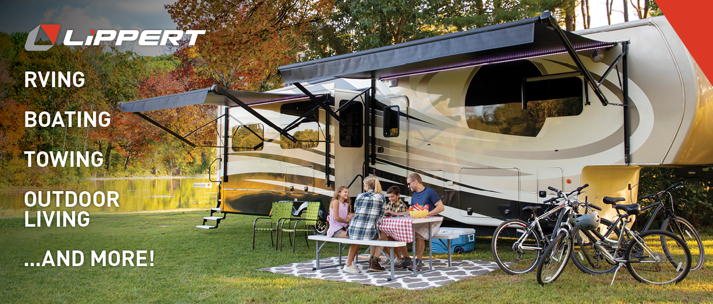 family in front of rv having a meal