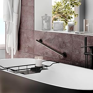 saftey grab bar on natural stone wall by bathtub