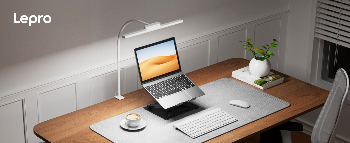 Text reads 'Lepro'. Workspace setup showing monitor stand in use on wooden desk with laptop, monitor, and small plant, demonstrating ergonomic height adjustment.