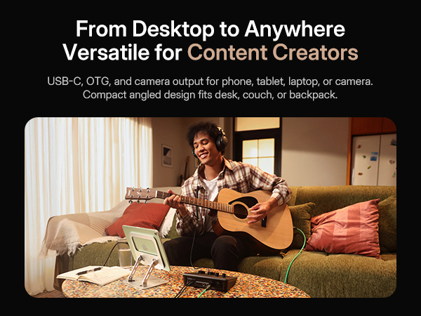 Music creator playing guitar recording music on couch with portable Maono P2 audio interface
