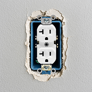 images demonstrating the jumbo outlet cover&amp;#39;s 5.5-inch size hiding damage