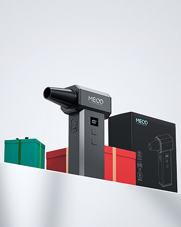 Meco branded handheld massage device with cylindrical body and protruding tip. Shown with gift boxes and product packaging against white background.