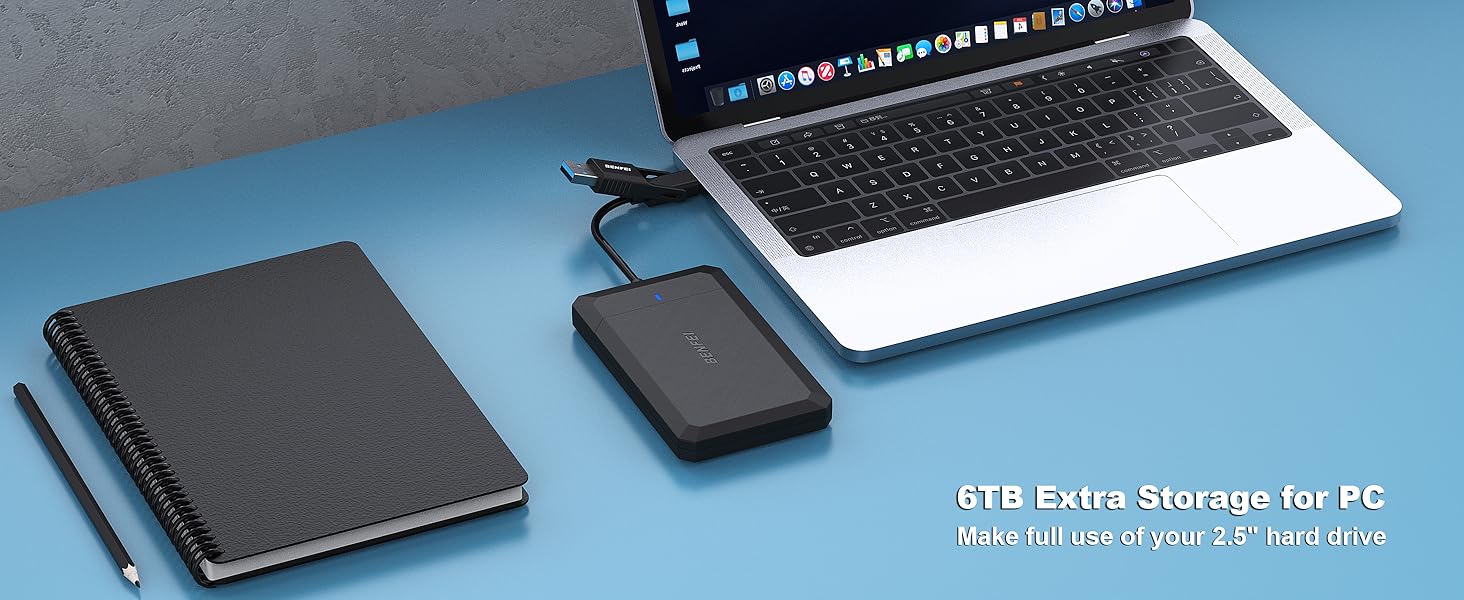Laptop, black notebook, and external hard drive on blue surface. Text reads '6TB Extra Storage for PC' indicating hard drive capacity.