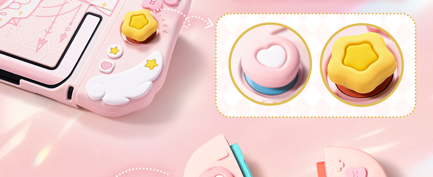 Pink gaming controller with two circular button attachments shown separately. Buttons feature heart and pentagon shapes in pastel colors.