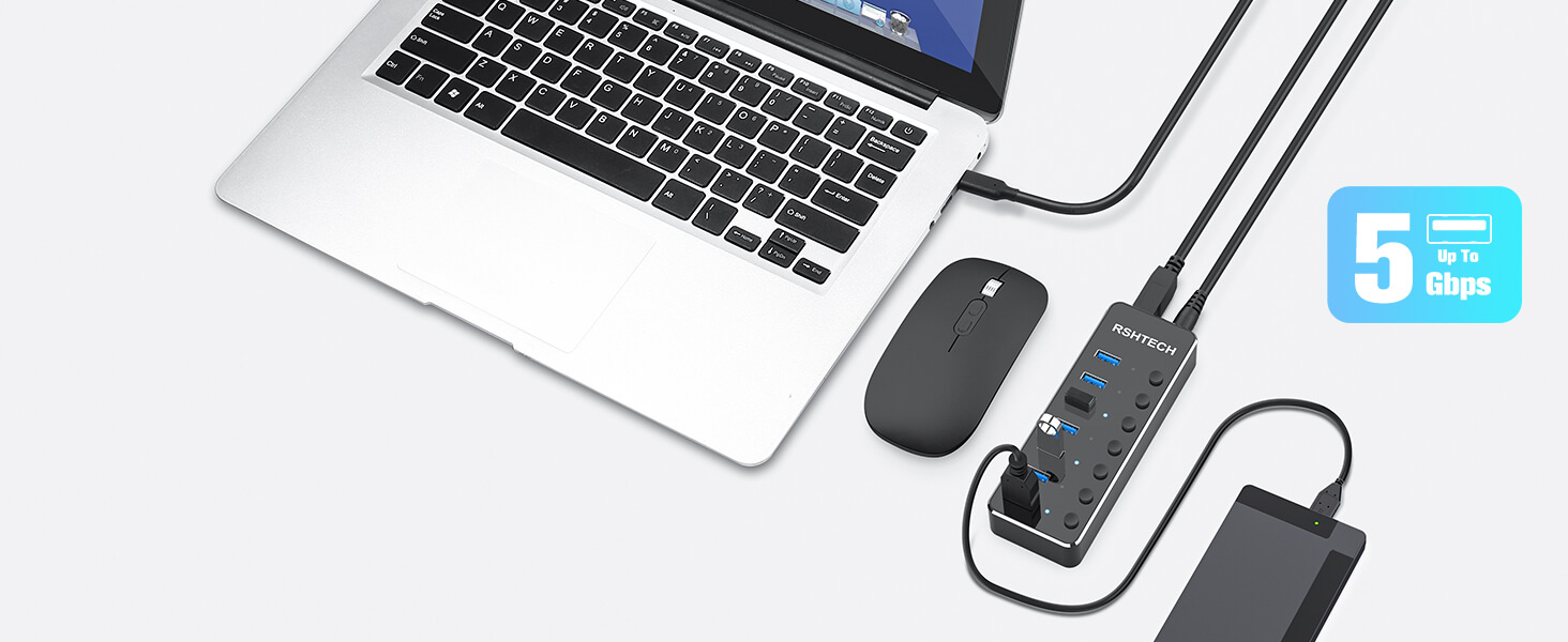 a laptop computer with a mouse and a power strip.