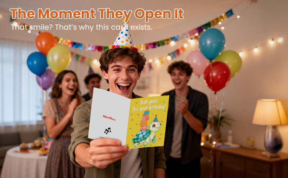 Man laughing and holding a funny musical turtle birthday card at a party