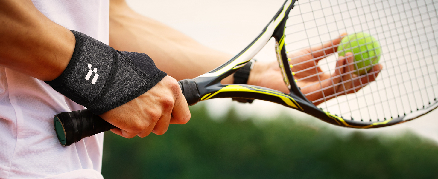 a close up of a person holding a tennis racket