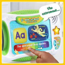 Kid follows along with words on flash card. The flash card reader says, The astronaut…