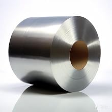 Large cylindrical roll of metal foil or sheet, likely aluminum or stainless steel, with a smooth, reflective surface. Hollow core visible.