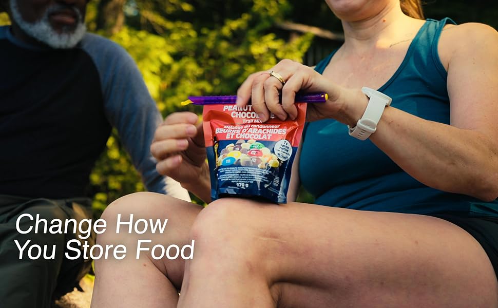 Woman opening a bag of trail mix with GripStic