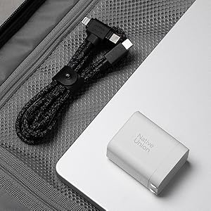 a laptop and a charger are sitting on a table.