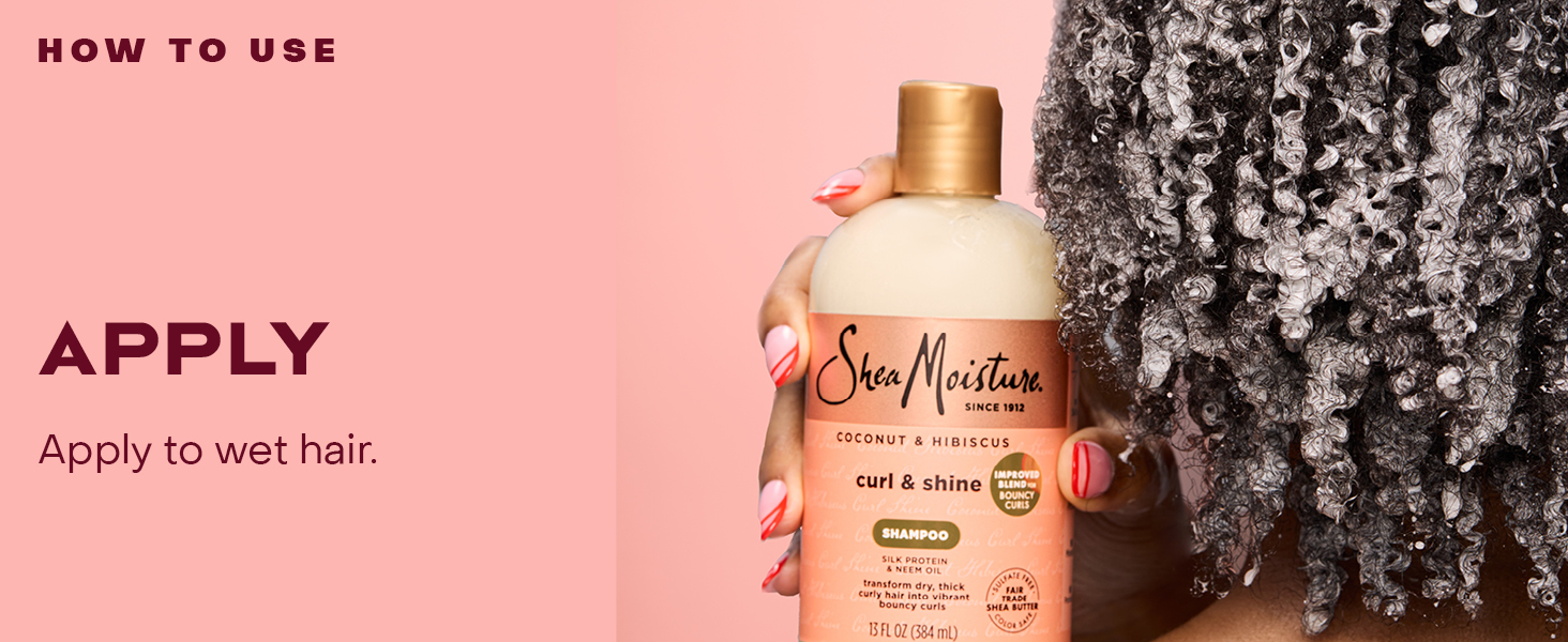Image of a woman&amp;#39;s hand holding a Curly &amp;amp; Shine Shampoo bottle, next to applying instructions.