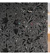 Abstract black and gray pattern featuring repeated floral or foliage motifs in a dense, decorative arrangement.