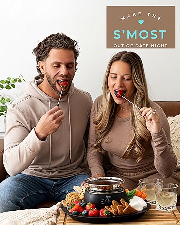 a couple enjoying chocolate dipped strawberries with the Kusini Chocolate fondue