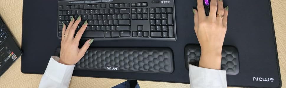 Extended desk pad and ergonomic wrist rest for a professional setup.