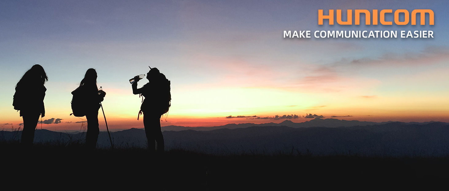 silhouette of a hiker standing on a hill at sunset