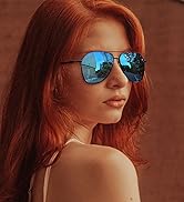 Aviator sunglasses with blue reflective lenses worn by a person with long red hair against a brown background.