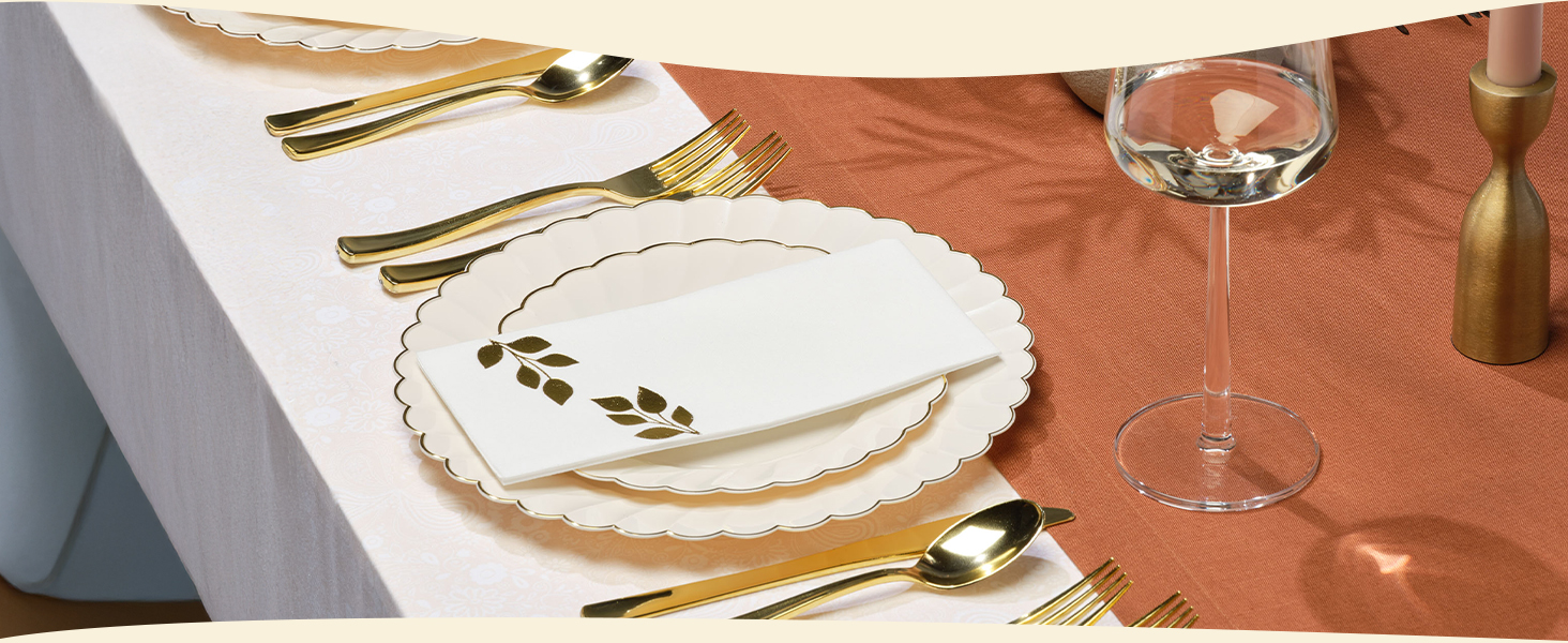 Ivory Scalloped Plastic Plates with Gold Trim on a high end table with wine glass and cutlery