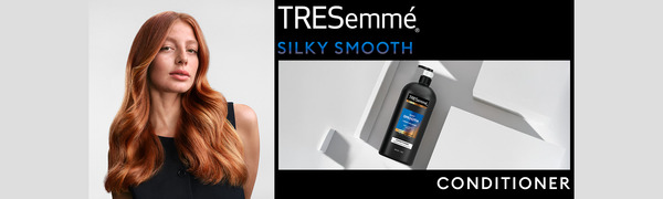 Red-haired model with soft waves beside a TRESemmé conditioner bottle on a modern white backdrop.