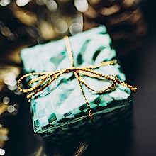 a gift box with a gold ribbon tied around it