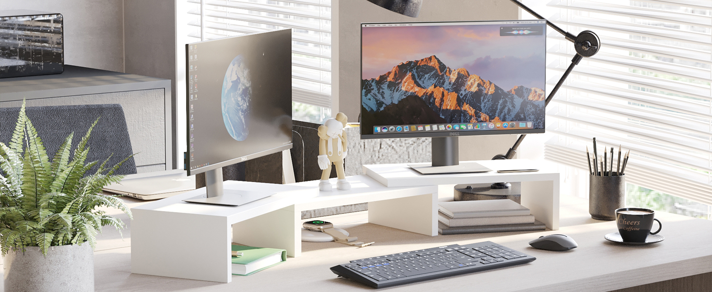 Modern home office setup with large monitor, wireless keyboard, potted plant, and minimalist white desk organizer. Clean, organized workspace with natural light.
