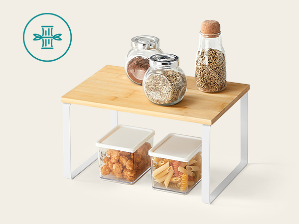 a white table with a glass storage container on top.