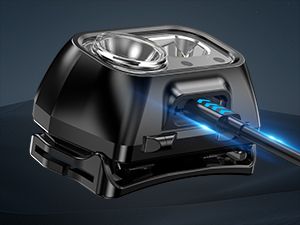 Black electronic device with clear lens housing and blue illuminated feature, appearing to be a sensor or scanning component.