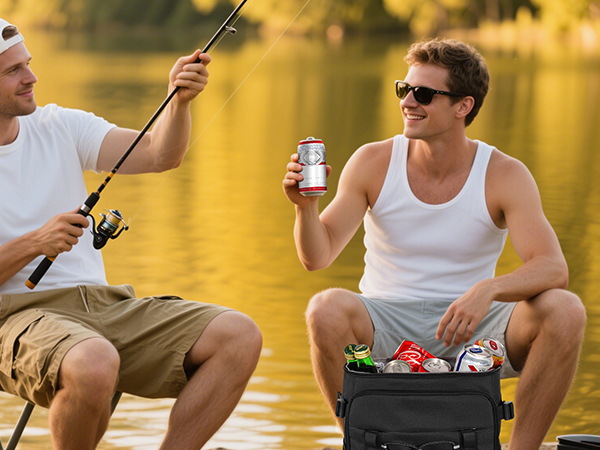 Two men fishing at the lake, drinking iced drinks from their cooler backpacks
