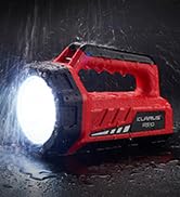 Red portable spotlight or flashlight illuminated against dark background, showing robust construction with grip handle.