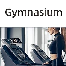 Treadmill with digital display in a gym setting. Woman in black workout attire visible using the machine. Multiple treadmills visible in background.