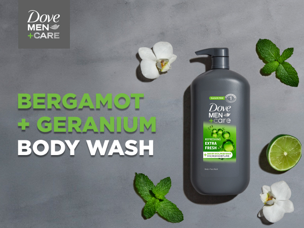 Pump bottle of Dove Men+Care Body Wash on a gray stone surface, surrounded by mint, flowers &amp; lime.