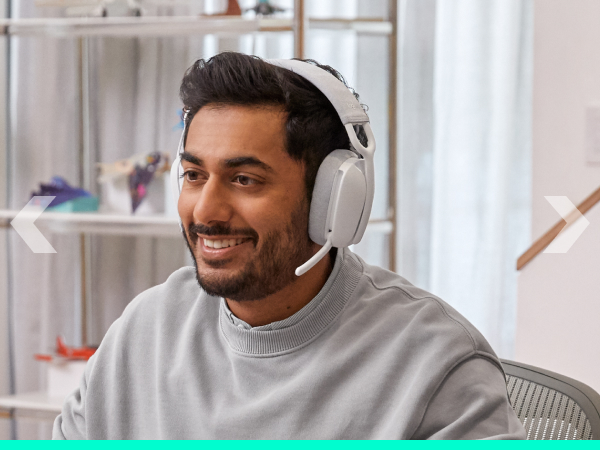 A man wearing Zone Vibe 100 (Off-White) and working on a computer