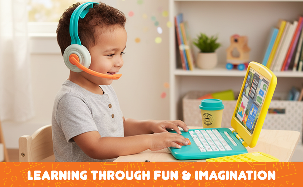Young boy wearing headset playing on colorful toy laptop at desk with coffee cup and calculator.