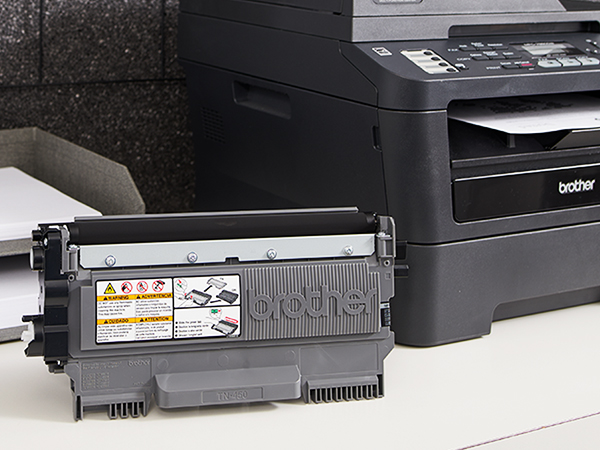 TN450 Toner Cartridge Next to Printer
