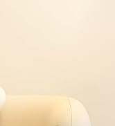 Someone wearing blue cleaning gloves spraying cleaning solution on a window or glass surface with natural light in the background.