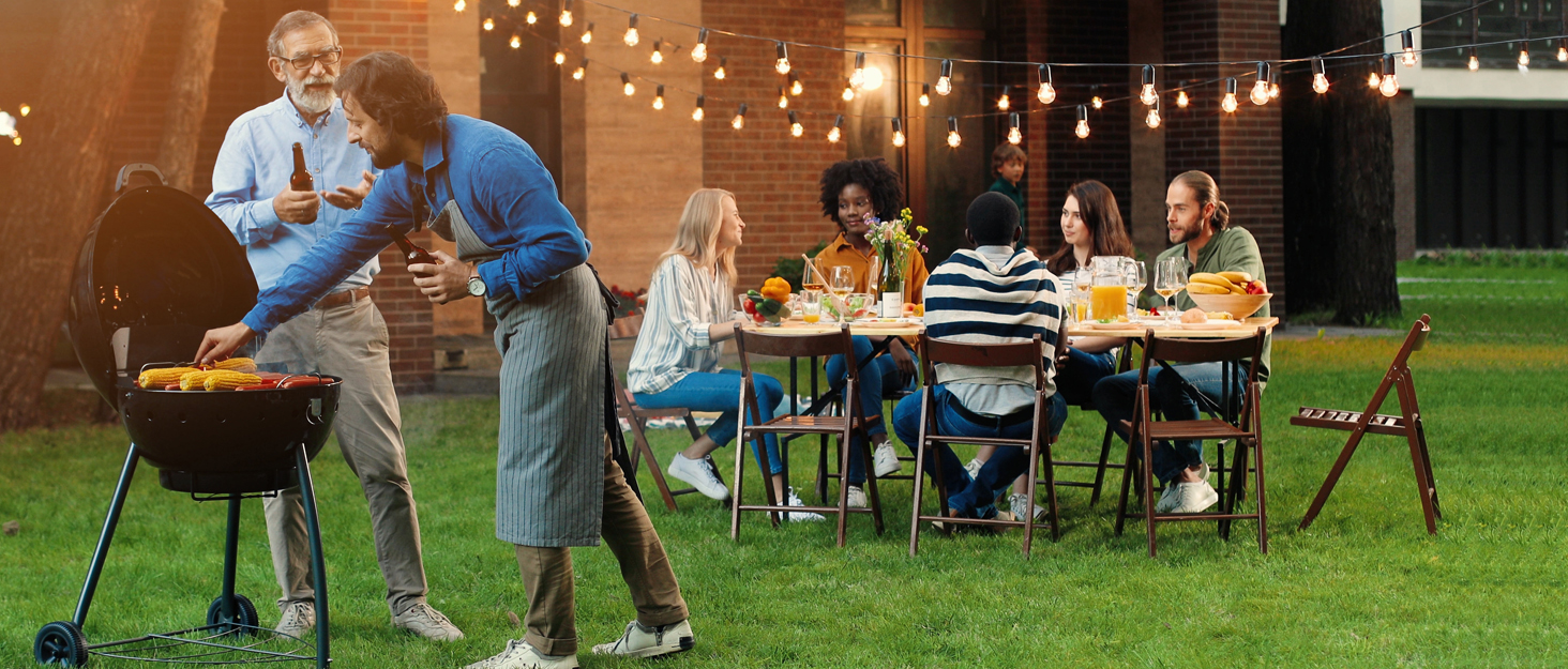 a group of people sitting around a table with food and drinks.