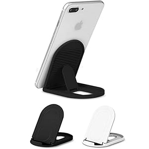 Foldable phone stand in black and white options. Shows stand supporting a white smartphone in portrait orientation.