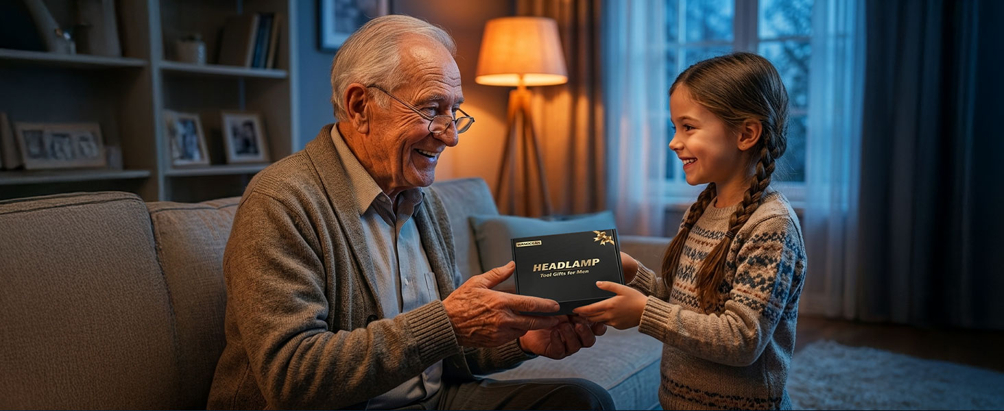 Elderly man and young girl sitting on couch exchanging a small rectangular device with blue accents in warm home setting with lamp and bookshelves.