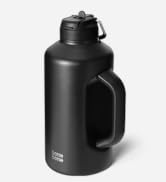 Large black insulated water bottle with wide handle and flip-top lid. Matte finish, cylindrical shape. Brand name visible on lower portion.