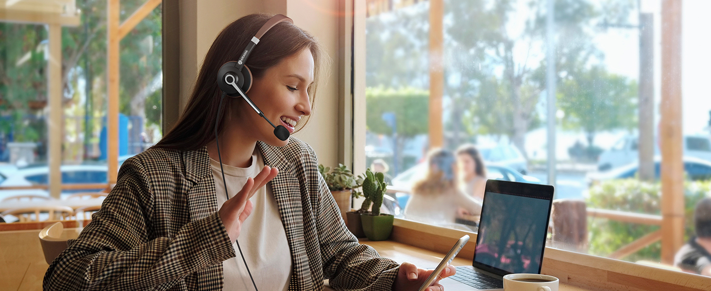 A woman wearing ARA700 wired headset is video-calling a friend.