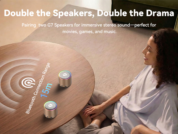 Text reads 'Double the Speakers, Double the Drama' and 'Pairing Pro G2 Speakers for immersive stereo sound—perfect for music, games, and more.' Woman adjusting controls on large beige circular speaker with tactile interface buttons.